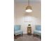 Sitting area showcasing matching blue chairs, and a wooden table beneath a decorative white wall hanging at 607 Gran Bahama Blvd # B29/U607, Davenport, FL 33897