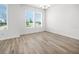 Bright dining room featuring wood-look floors and natural light from large windows at 6501 Cyrils Dr, St Cloud, FL 34771