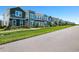 New construction townhomes boast vibrant colors, lush landscaping, and a sidewalk at 6501 Cyrils Dr, St Cloud, FL 34771