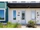 Entrance of townhome with white door, modern fixtures, and craftsman details at 6501 Cyrils Dr, St Cloud, FL 34771