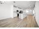 Open floor plan showcases white kitchen, stainless steel appliances, and a kitchen island at 6501 Cyrils Dr, St Cloud, FL 34771