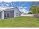 Lush backyard with a screened-in lanai, offering a private outdoor living space and a well-maintained lawn at 664 Eagle Pointe S, Kissimmee, FL 34746