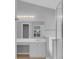 Well-lit bathroom featuring a vanity with a sink, a large mirror, and a glass-enclosed shower at 664 Eagle Pointe S, Kissimmee, FL 34746
