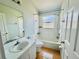This bathroom features a shower-tub combo with white tile and a vanity with a sink and mirror at 664 Eagle Pointe S, Kissimmee, FL 34746