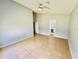Spacious primary bedroom featuring tile flooring and an ensuite bathroom at 664 Eagle Pointe S, Kissimmee, FL 34746