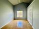 A clean bedroom featuring tile floors, closet, and a window with bright, natural light at 664 Eagle Pointe S, Kissimmee, FL 34746