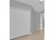 Bedroom with neutral walls, tiled floors, closet and a view of the hallway at 664 Eagle Pointe S, Kissimmee, FL 34746
