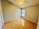 Bright bedroom featuring tile floors and a window with natural light creating a calm atmosphere at 664 Eagle Pointe S, Kissimmee, FL 34746