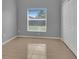Comfortable bedroom featuring tiled floors, a closet, and a window with backyard views at 664 Eagle Pointe S, Kissimmee, FL 34746