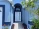 A close-up of a charming blue home featuring a manicured lawn, and inviting front entrance at 664 Eagle Pointe S, Kissimmee, FL 34746