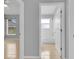 Hallway view showcasing tile flooring and doorways to the bathroom and bedroom with natural light at 664 Eagle Pointe S, Kissimmee, FL 34746