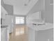 Bright kitchen featuring white cabinets, sleek countertops, and a tiled floor, bathed in natural light at 664 Eagle Pointe S, Kissimmee, FL 34746