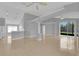 Open-concept living space featuring tiled floors, modern lighting, and seamless access to the kitchen at 664 Eagle Pointe S, Kissimmee, FL 34746