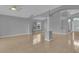 Spacious living area with tiled floors, large windows, and a view of the front entryway at 664 Eagle Pointe S, Kissimmee, FL 34746
