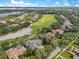 Aerial view of homes, golf course, lakes, and tree covered landscapes in community at 6761 Valhalla Way, Windermere, FL 34786