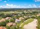 Aerial view of community, lake, tree covered area, and golf course at 6761 Valhalla Way, Windermere, FL 34786