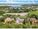 Aerial view of community, golf course, pond and surrounding tree covered area at 6761 Valhalla Way, Windermere, FL 34786