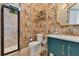 Exquisite bathroom featuring marble countertop, patterned wall, and glass shower at 6761 Valhalla Way, Windermere, FL 34786
