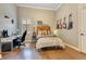 This bedroom has a desk, hard wood floors, and musical themed wall decorations for an energetic style at 6761 Valhalla Way, Windermere, FL 34786
