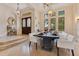 Elegant dining room featuring modern lighting, hardwood floors, and large windows at 6761 Valhalla Way, Windermere, FL 34786