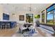 Well-lit dining room with bar, table, large windows, and a shuffleboard table at 6761 Valhalla Way, Windermere, FL 34786