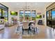 Dining room features a round table, four chairs, modern lighting and an outdoor view at 6761 Valhalla Way, Windermere, FL 34786
