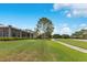 Green lawn and backyard with partially covered patio and lush landscaping at 6761 Valhalla Way, Windermere, FL 34786