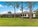 Expansive green lawn and backyard with covered patio and landscaped hedges at 6761 Valhalla Way, Windermere, FL 34786