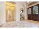 Elegant foyer with tile flooring, a decorative mirror, and a solid wood front door at 6761 Valhalla Way, Windermere, FL 34786
