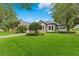 Charming home with mature trees, lush lawn, and a brick driveway at 6761 Valhalla Way, Windermere, FL 34786