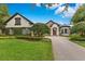 Charming home with mature trees, lush lawn, and a brick driveway at 6761 Valhalla Way, Windermere, FL 34786