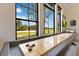 Bright game room with a shuffleboard table and large windows overlooking the golf course at 6761 Valhalla Way, Windermere, FL 34786