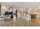 Open-concept kitchen featuring a large island, hardwood floors, and a cozy fireplace in the hearth room at 6761 Valhalla Way, Windermere, FL 34786