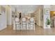 Elegant kitchen island with bar stool seating, custom cabinetry, and hardwood floors at 6761 Valhalla Way, Windermere, FL 34786