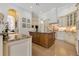 Gourmet kitchen featuring custom cabinets, a center island, and granite countertops at 6761 Valhalla Way, Windermere, FL 34786