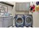 Well-equipped laundry room with gray cabinetry, modern appliances, and ample counter space at 6761 Valhalla Way, Windermere, FL 34786