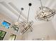 Decorative, multi-sphere chandeliers adorn the dining room of this home at 6761 Valhalla Way, Windermere, FL 34786