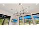 Modern lighting fixture hanging above an open living and dining area at 6761 Valhalla Way, Windermere, FL 34786
