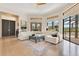 Bright living room boasts a white sectional sofa, large windows, and stylish decor at 6761 Valhalla Way, Windermere, FL 34786