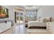 Bright main bedroom featuring plantation shutters, hardwood floors, and private patio access at 6761 Valhalla Way, Windermere, FL 34786