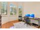 Bright office space with two windows, hardwood floors, and built in bookshelves at 6761 Valhalla Way, Windermere, FL 34786