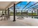 Gorgeous covered pool and hot tub area complete with outdoor seating and elegant column supports at 6761 Valhalla Way, Windermere, FL 34786