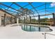 Beautiful screened-in pool with a spa, surrounded by lush landscaping, perfect for relaxation at 6761 Valhalla Way, Windermere, FL 34786