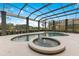 Beautiful covered pool and hot tub with lush backyard landscaping at 6761 Valhalla Way, Windermere, FL 34786