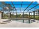 Sparkling pool and spa with a screened enclosure and views of the surrounding greenery at 6761 Valhalla Way, Windermere, FL 34786