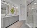 Modern bathroom featuring dual sinks, a walk-in shower, and neutral color scheme at 6970 Piazza St, Orlando, FL 32819