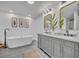 Luxurious bathroom featuring a freestanding tub, dual vanities, and modern finishes at 6970 Piazza St, Orlando, FL 32819