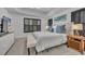 Bright bedroom with white furnishings, dark shutters, and a tray ceiling at 6970 Piazza St, Orlando, FL 32819