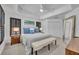 Bright bedroom with white furnishings, dark shutters, and a tray ceiling at 6970 Piazza St, Orlando, FL 32819