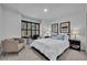 Cozy bedroom featuring a queen-size bed, reading chair, and a window with dark shutters at 6970 Piazza St, Orlando, FL 32819